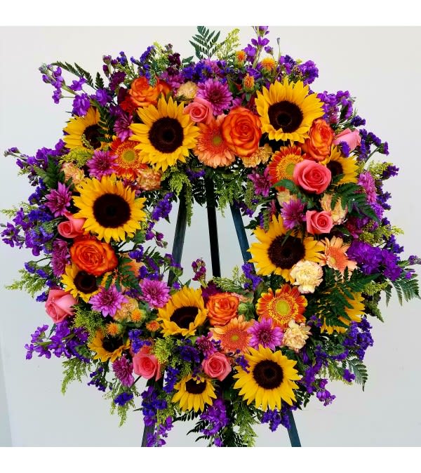 Large standing wreath of sunflowers, roses, and purple flowers