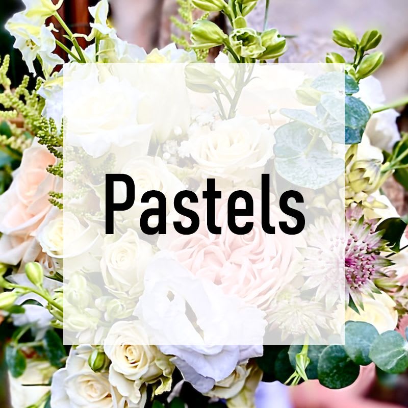 Pastel bouquet of white and blush flowers with text reading Pastels over the center