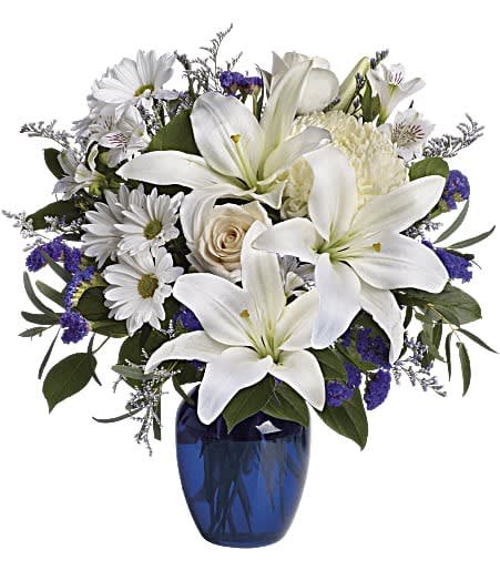 Beautiful in Blue - In this arrangement, the serenity of the color blue along with the purity of intention symbolized by white will let the family know you are sending your calm strength to them during these difficult times.