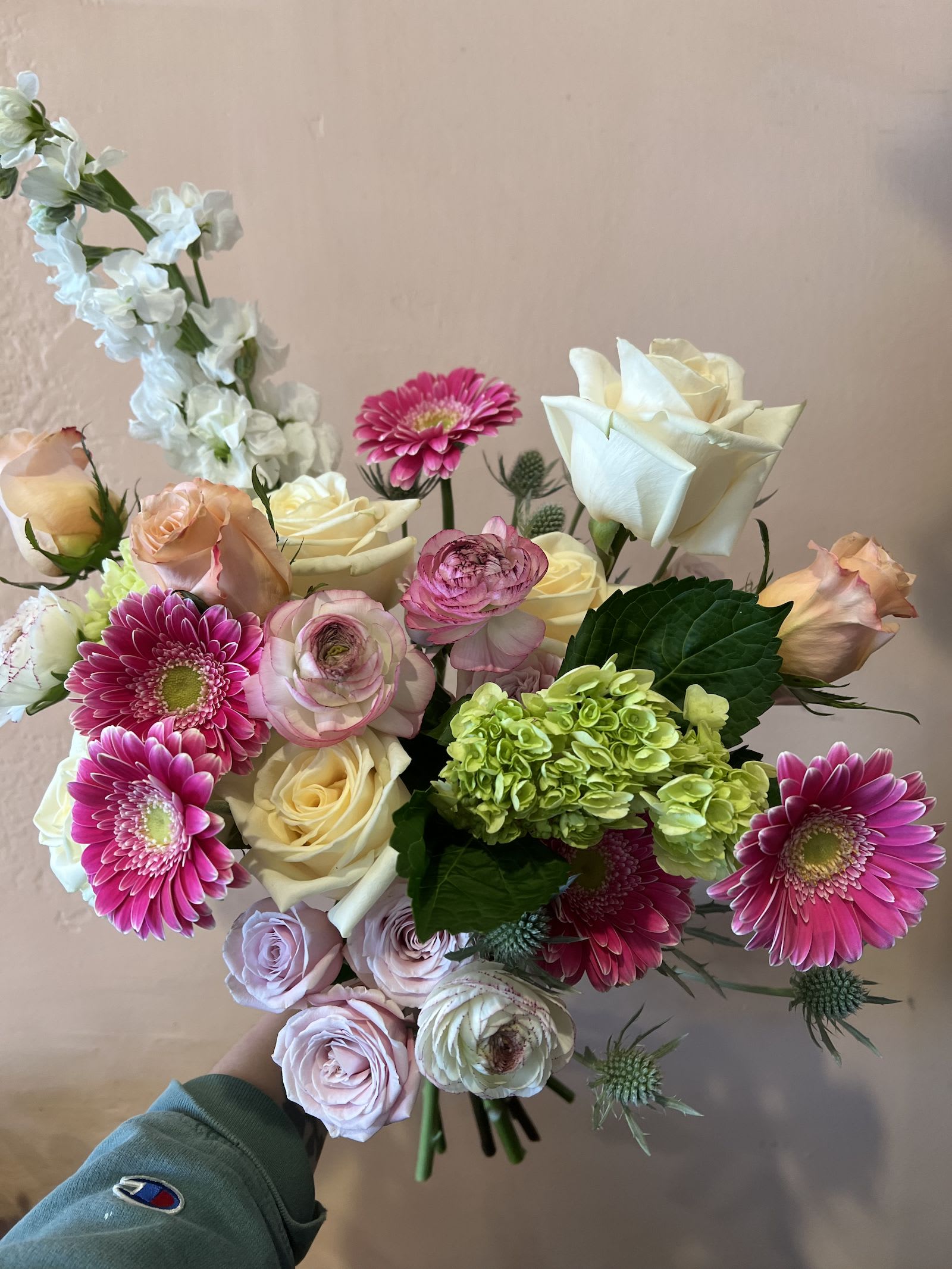 BUTTONED UP WRAPPED BOUQUET - Year round flowers that we typically stock: specialty rose, spray rose and garden rose, ranunculus, anemone, gerbera daisy, protea, lisianthus, chrysanthemum, larkspur, snapdragon, delphinium, stock, aster, dianthus, hypericum, feverfew, astrantia, leucodendron. 