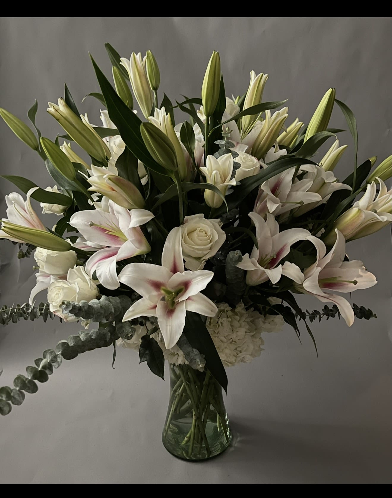White Rose Lilies Grand Design. - 50 setms of lilies with 2 dozen white roses. 