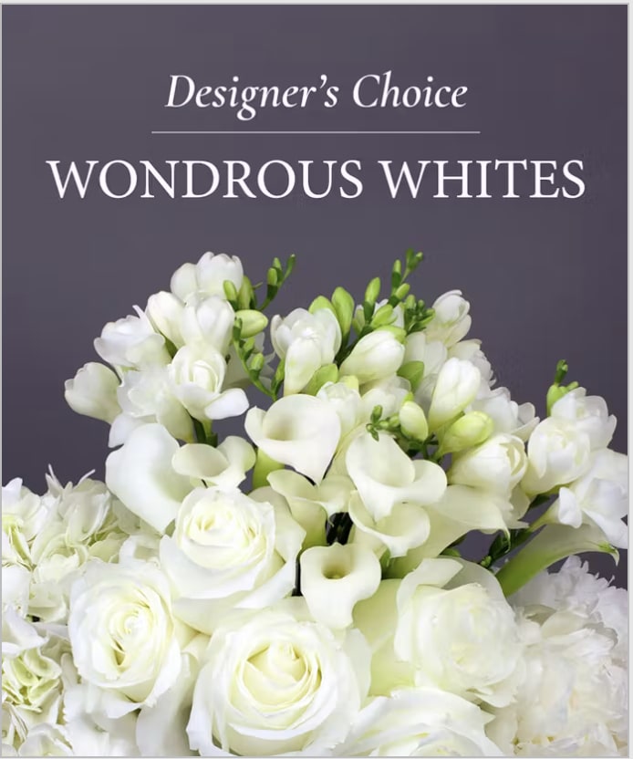 Designer Whites  - A lush cluster of pure white blooms designed to soothe and celebrate, this flower arrangement-perfect as a sympathy bouquet, wedding centerpiece, or an elegant everyday gift-features roses, mini calla lilies, and delicate freesia-like flowers for a timeless, serene impression. The all-white palette with fresh green buds creates a clean, graceful look that reads as both refined and comforting for the person you're thinking of.  The design is full and rounded with layered petals and soft textures that invite close inspection: velvety rose heads, sculpted mini calla lilies, and tiny freesia blossoms nestled among bright green accents. As a designer's choice arrangement, florists select the freshest seasonal stems to achieve this airy yet substantial composition; colors remain predominantly white with subtle green notes and any additional accents chosen to enhance the overall harmony.  A thoughtful pick for weddings, memorials, anniversaries, or simply to let someone know they're cared for, this arrangement is offered in multiple sizes so you can match the moment and your budget. Our designers customize each bouquet from the freshest stock-place your order and we'll create a tailored white arrangement that makes the recipient feel truly seen.