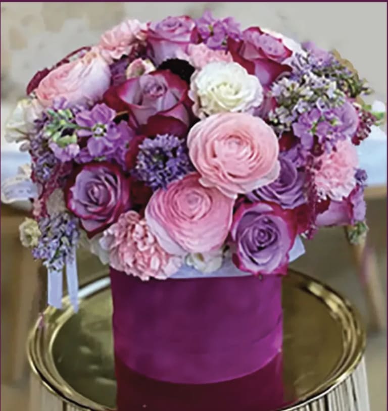 Pink and purple rose bouquet in a magenta hatbox