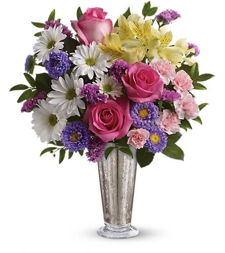 Bouquet of pink roses, daisies, and purple flowers in a silver vase