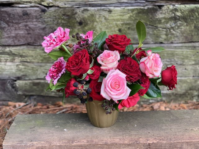 Bouquet of red and pink roses in a small vase