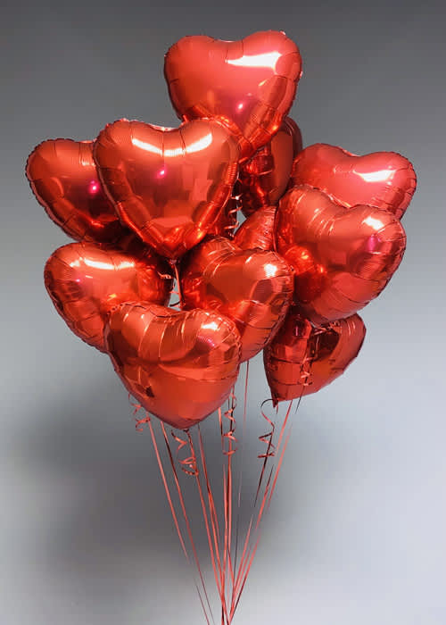 Cluster of red heart-shaped balloons on strings