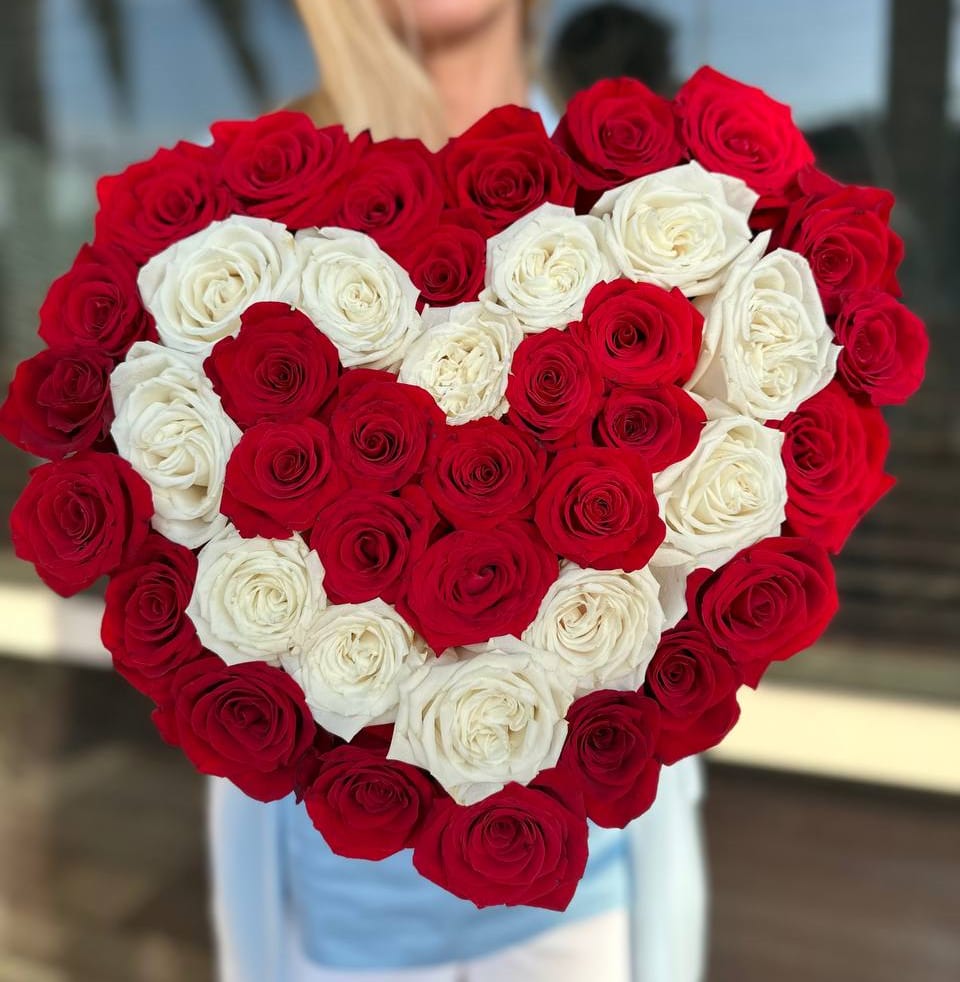 Heart-shaped bouquet of red and white roses
