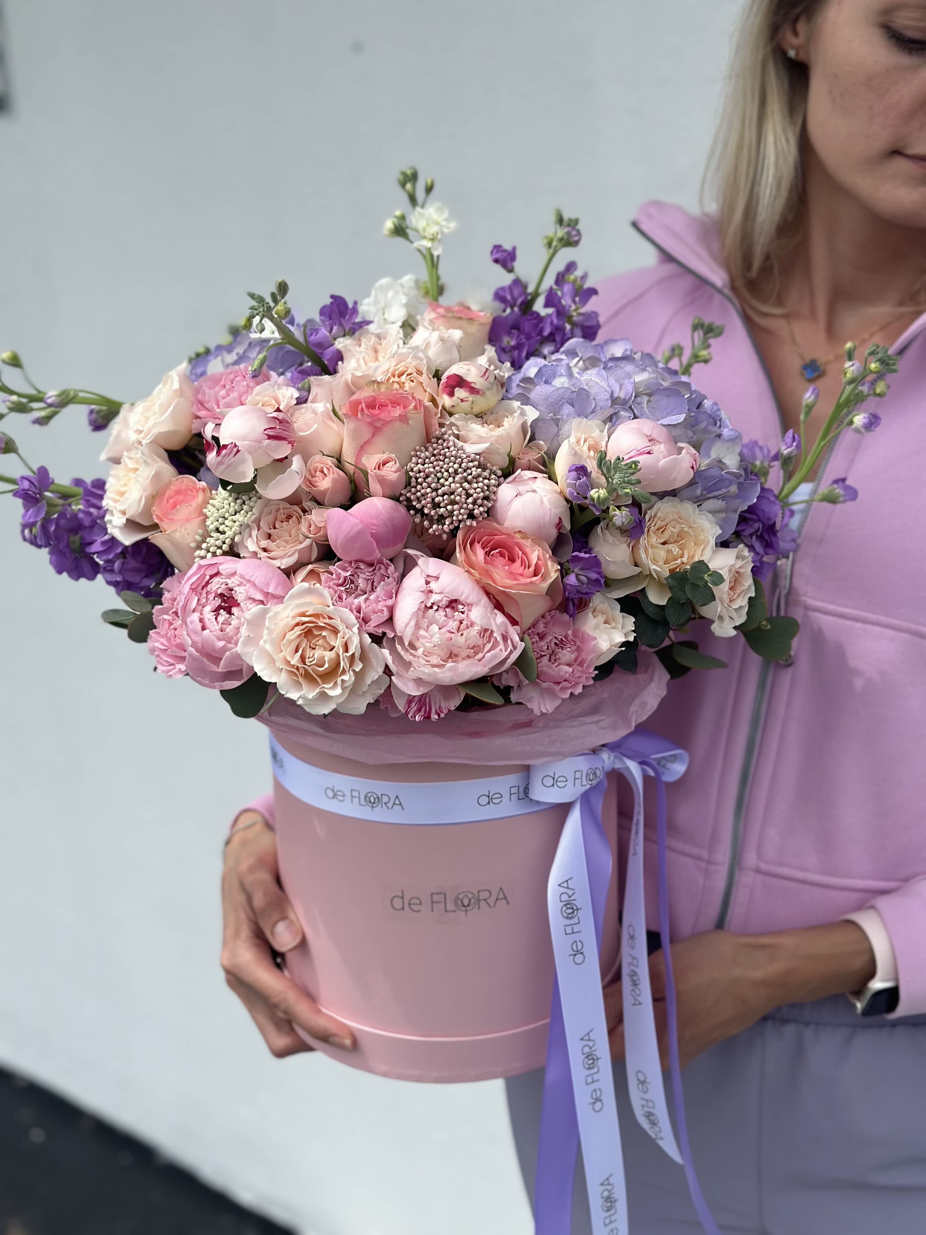 Large pastel bouquet in a pink hatbox with a lavender ribbon
