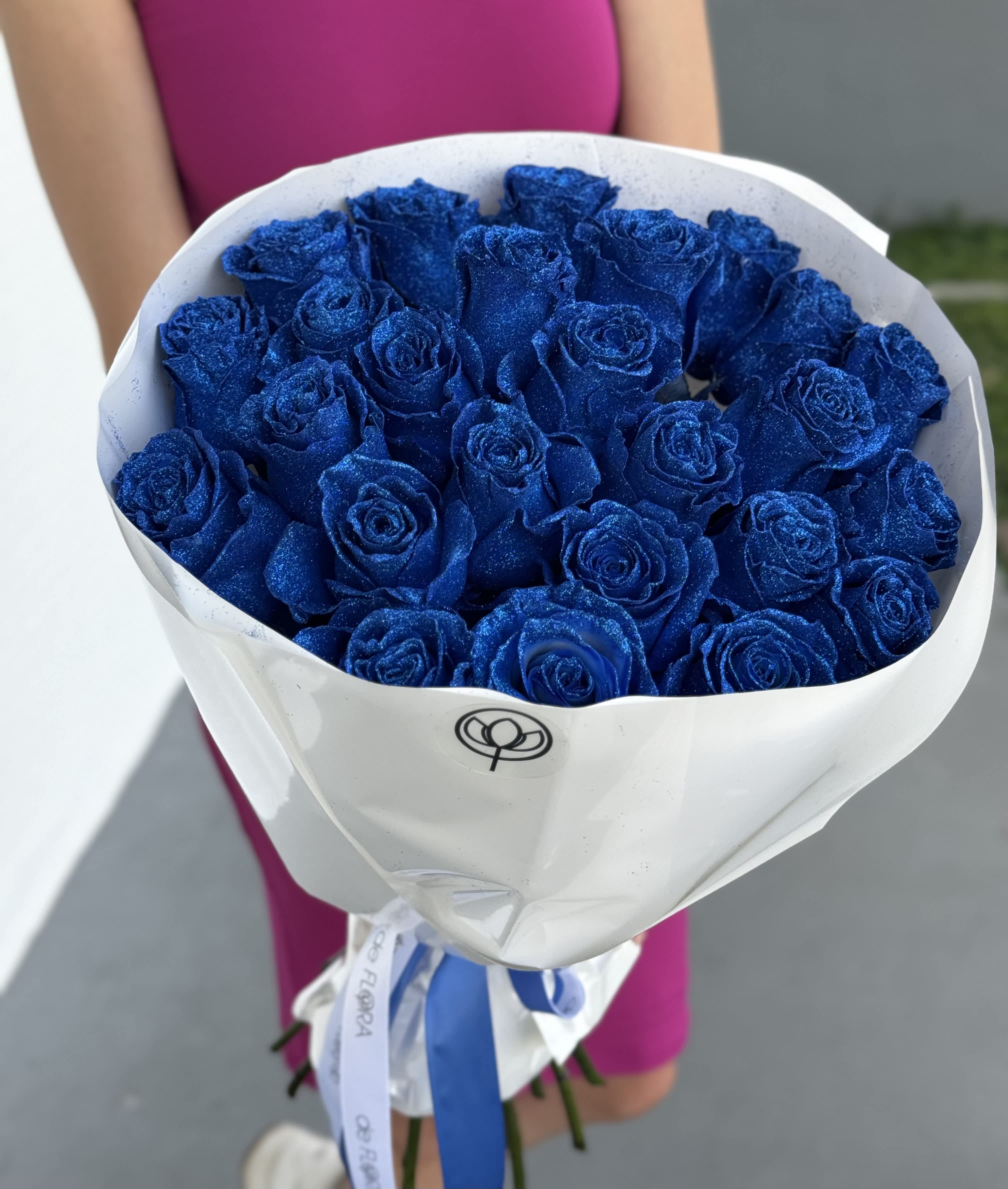 Bouquet of glittery blue roses wrapped in white paper