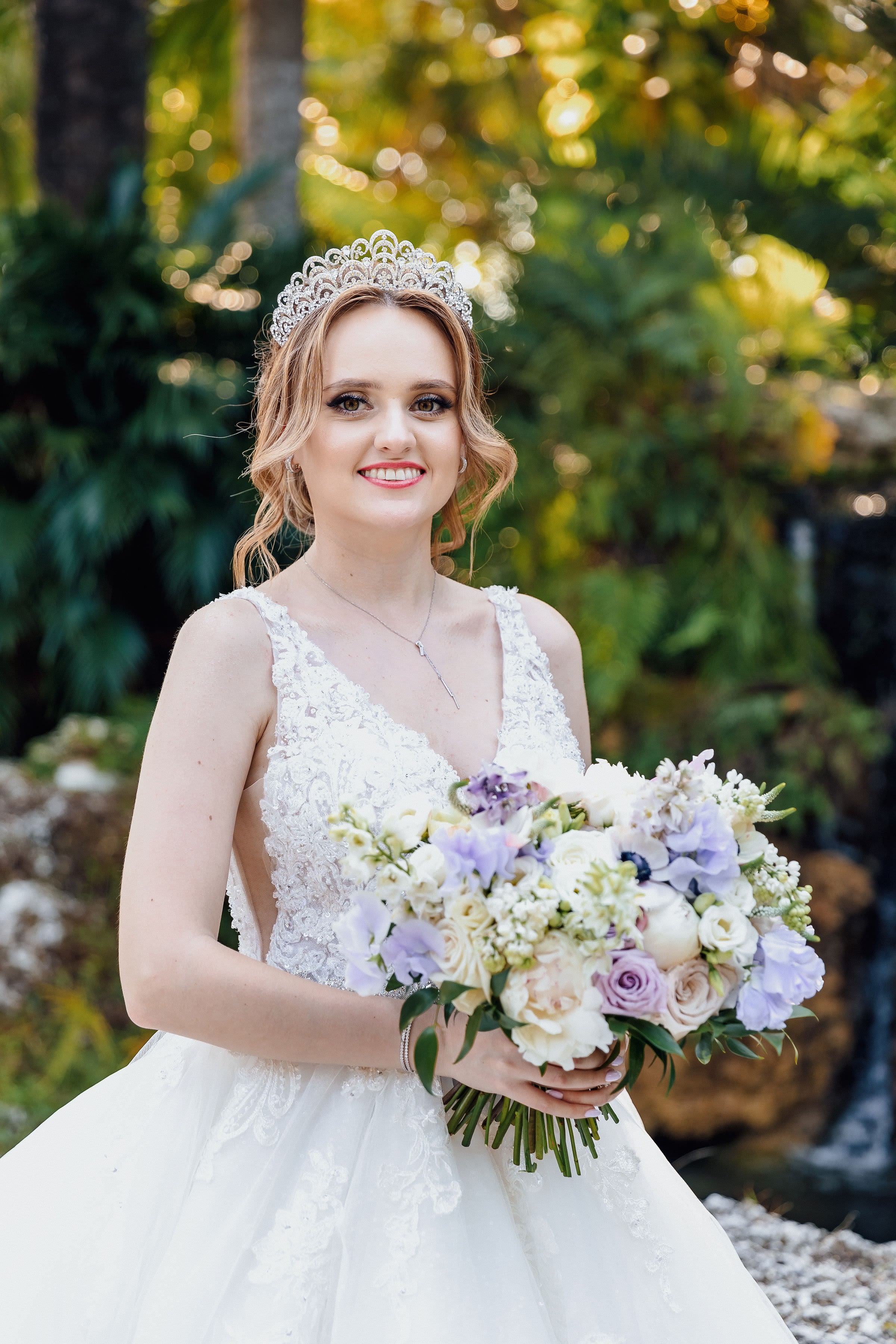 Bride holding a pastel bouquet and wearing a jeweled tiara