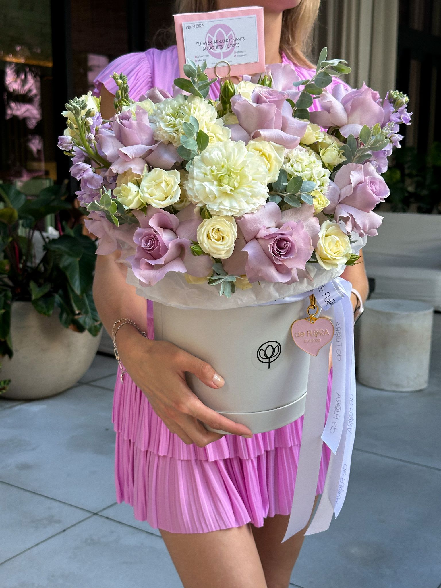 Lavender and cream bouquet in a round hatbox with ribbon