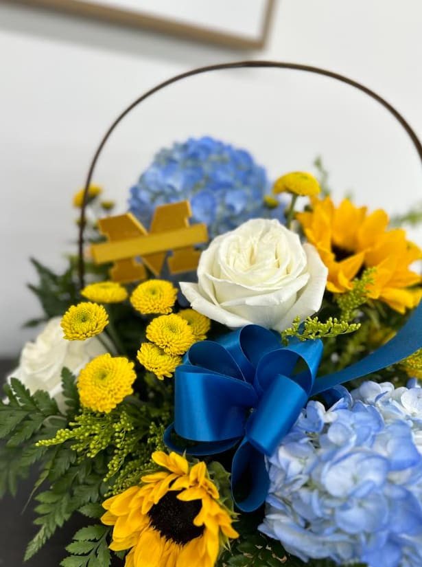 Country Breeze - Sunflowers and Blue Hydrangeas with a mix of other flowers and greens reminds us of a beautiful country meadow.  Prefect for any occasions.  