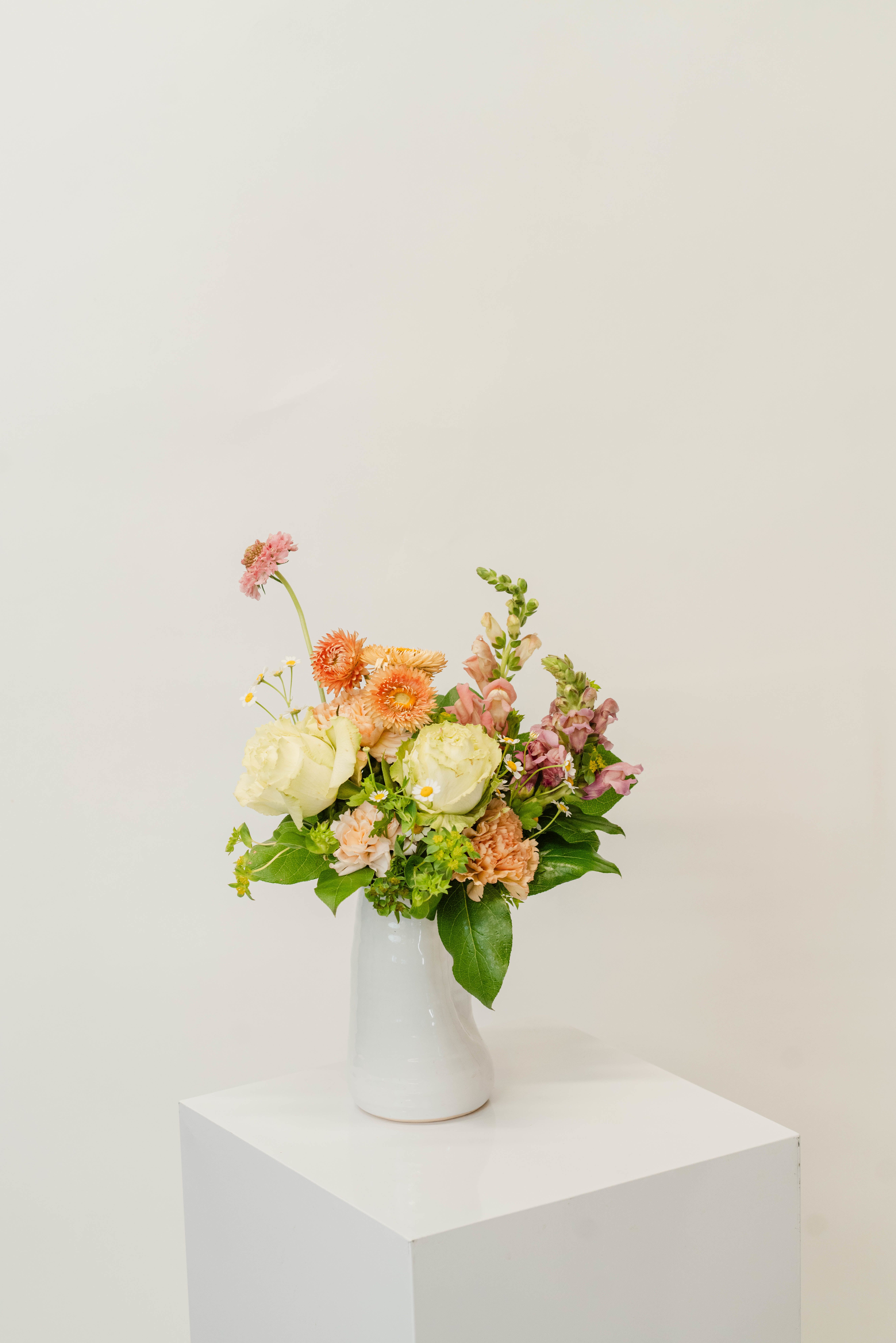 Mixed pastel bouquet in a white vase