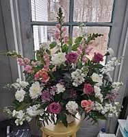 Mixed pink and white floral arrangement in a gold vase