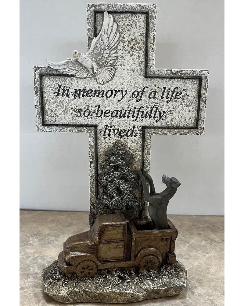 Memorial cross with a dove and truck figurine