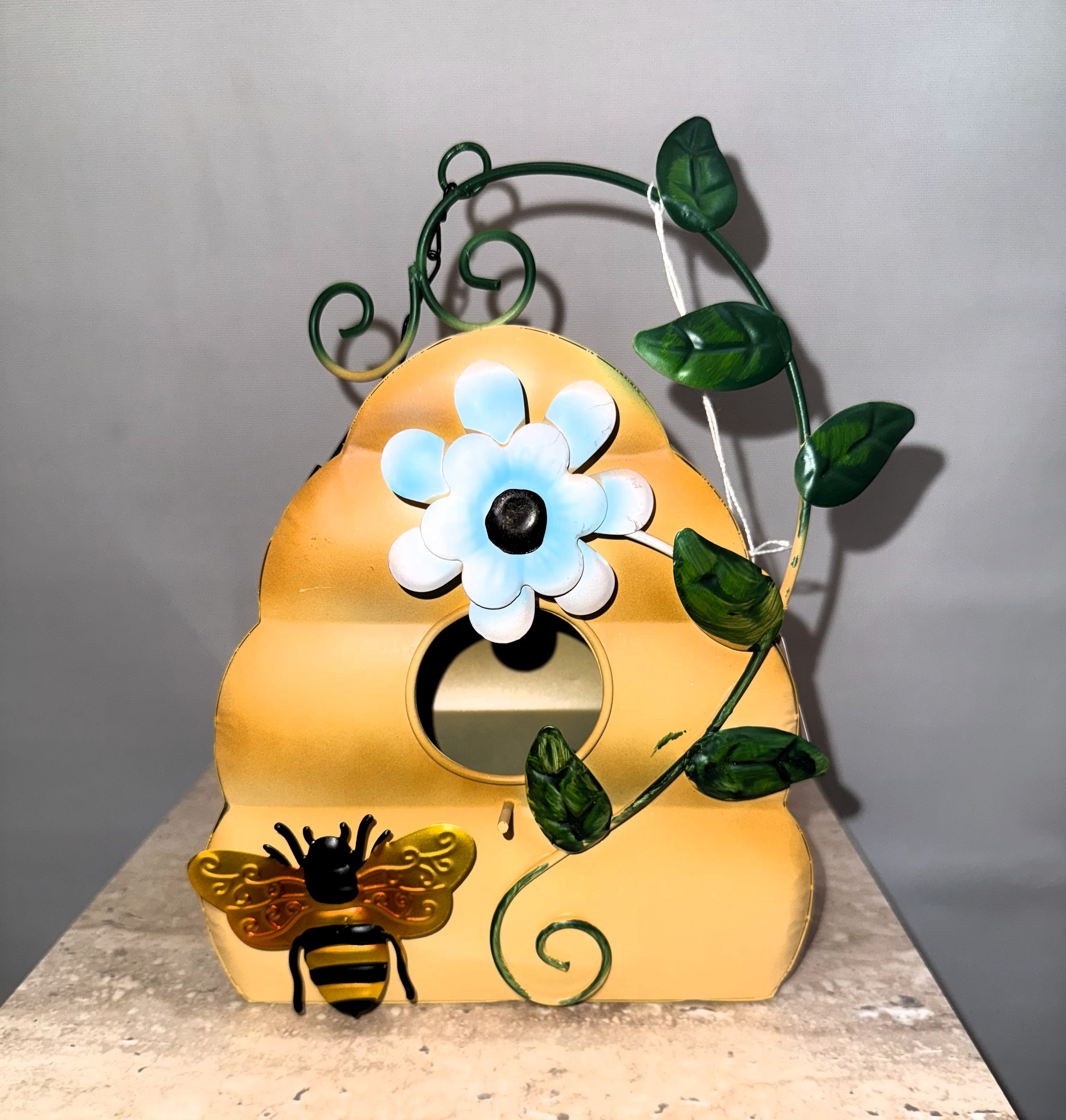 Decorative bee house with a painted flower and vine design