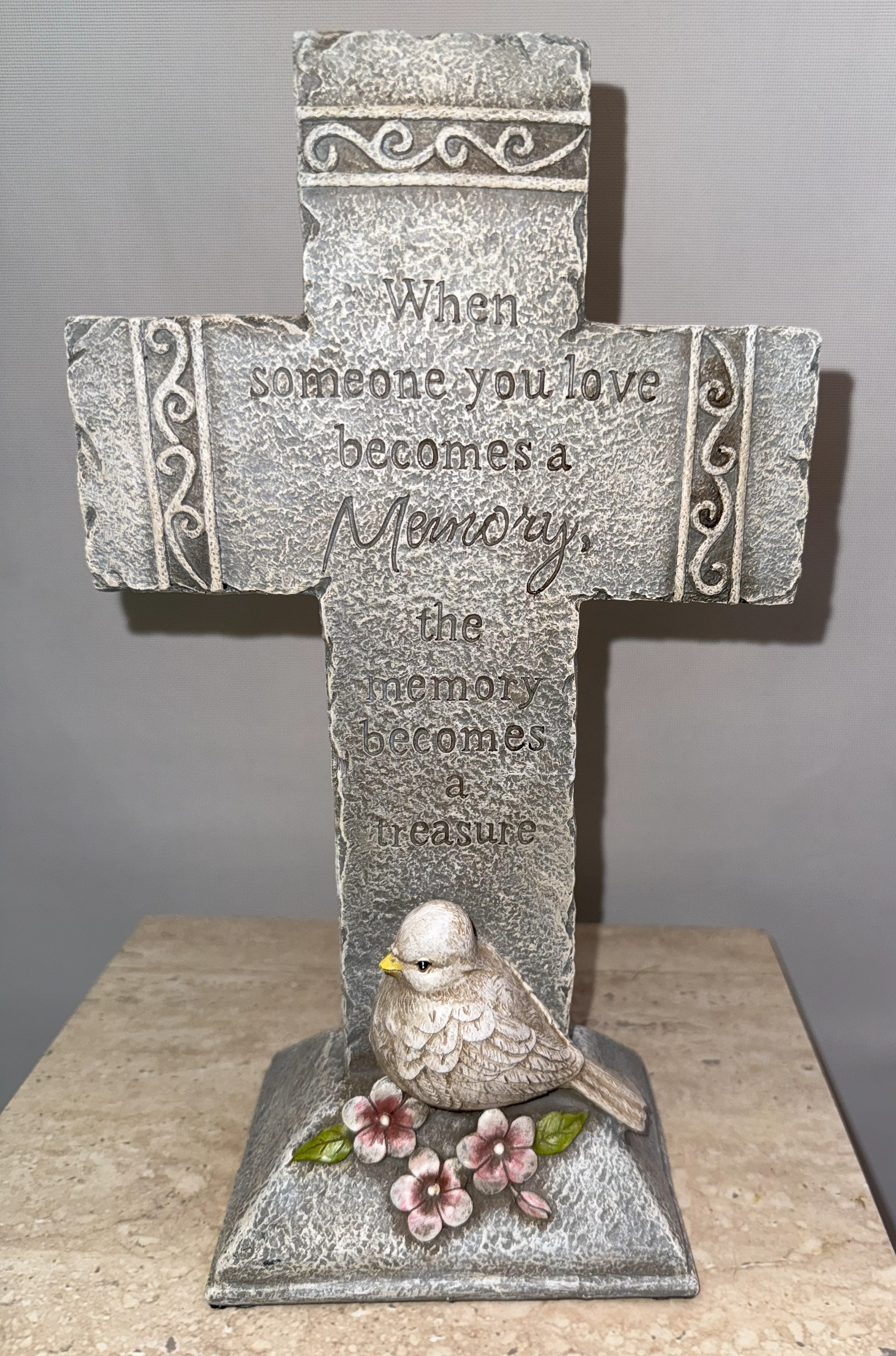 Decorative memorial cross with a bird and flowers
