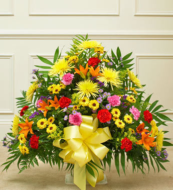 Heartfelt Tribute Bright Floor Basket Arrangement - Product ID: 91382   Share your most sincere expression of sympathy during a difficult time with this tasteful and elegant floor basket arrangement. Our expert florists hand arrange the freshest gathering of roses, spray roses, Gerberas, alstroemeria and more in shades of red, orange, yellow, pink and purple to help you convey your care and support while letting them know that brighter days are ahead. Floor basket arrangement of fresh, bright roses, mums, lilies, poms, carnations, statice and more Appropriate for family, friends or business associates to send directly to the funeral home Our florists use only the freshest flowers available, so colors and varieties may vary