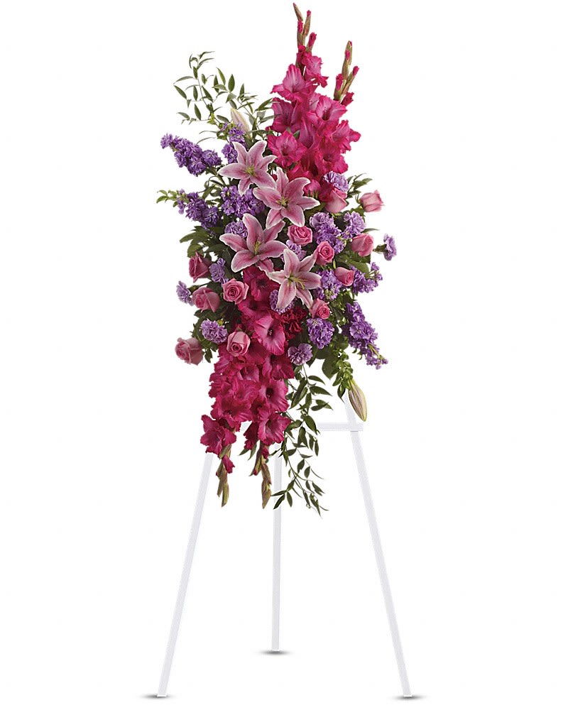 Tall standing floral spray with pink lilies, roses, and purple flowers