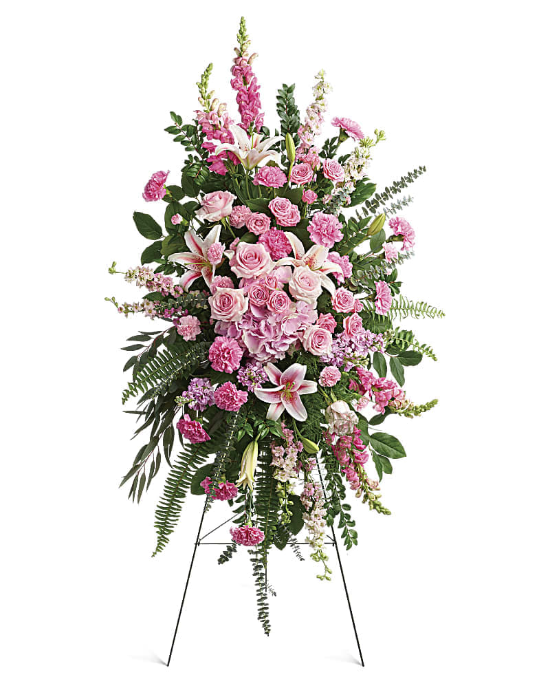 Tall pink floral standing spray on an easel
