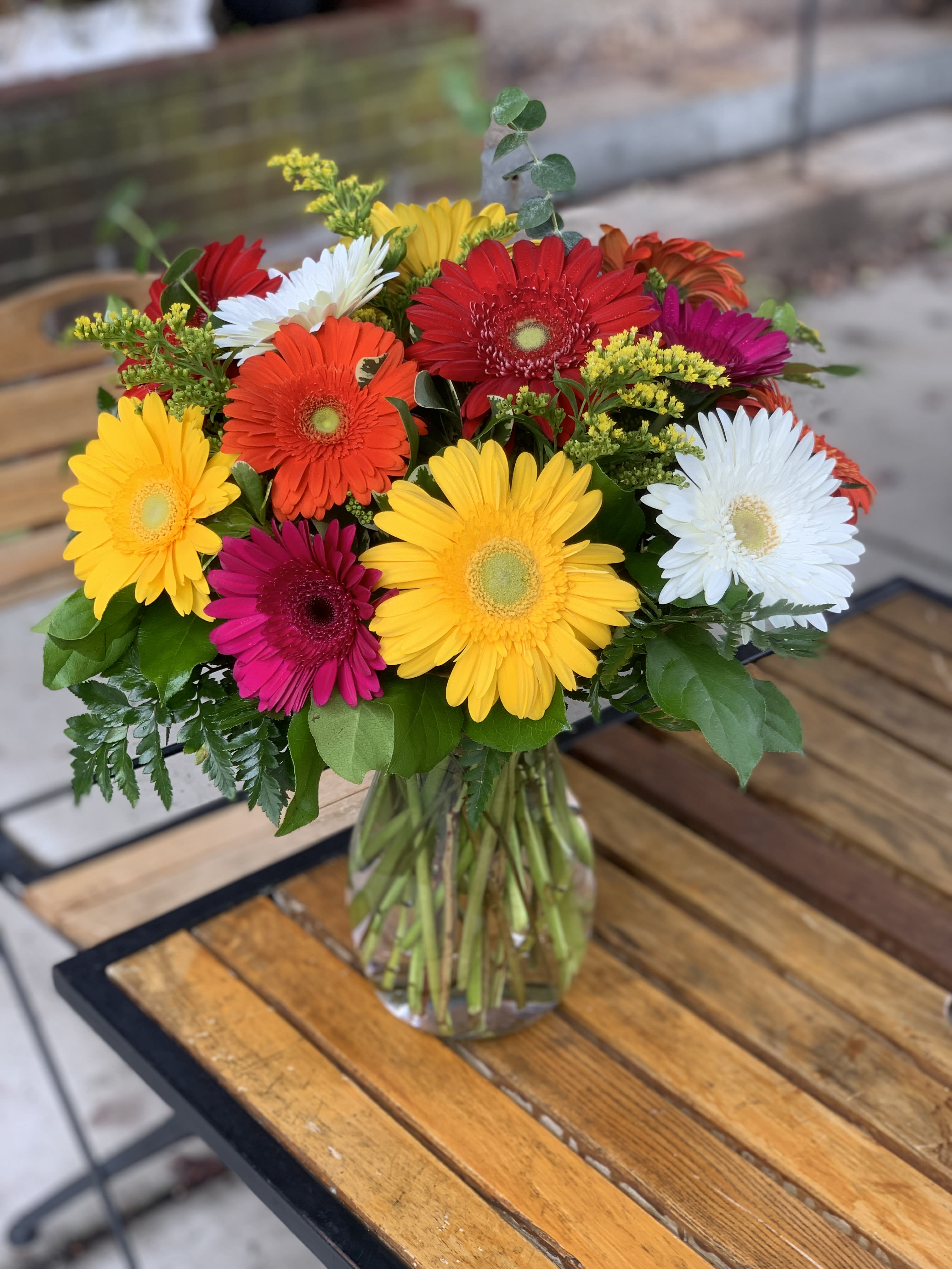 Colorful gerbera daisy bouquet in a clear glass vase
