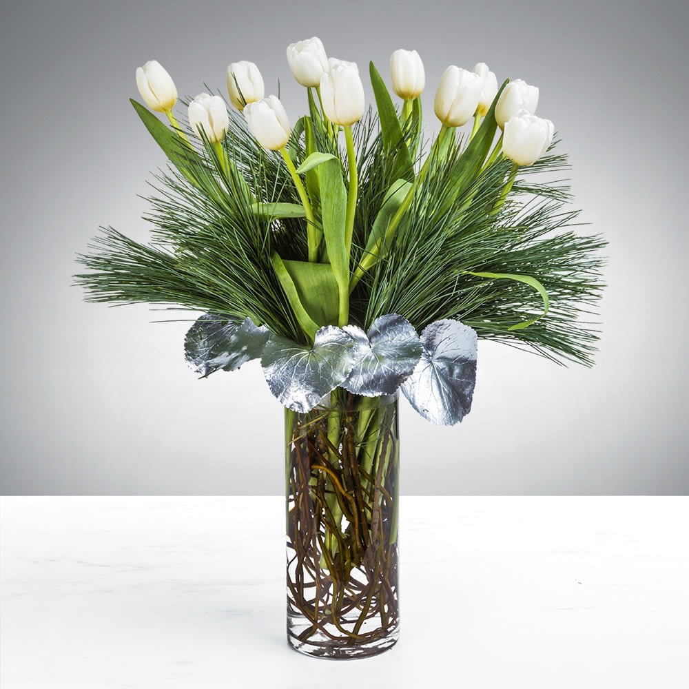 Tranquil Tulip by SWF - People spend lifetimes searching for inner peace. We’re not going to say the Tranquil Tulip arrangement will lead you immediately there. But, on the other hand, who wouldn’t want a bit of tulip comfort on their meandering path to lifelong serenity. Gift this arrangement to someone who deserves a bit of tranquility in their life this holiday season. 