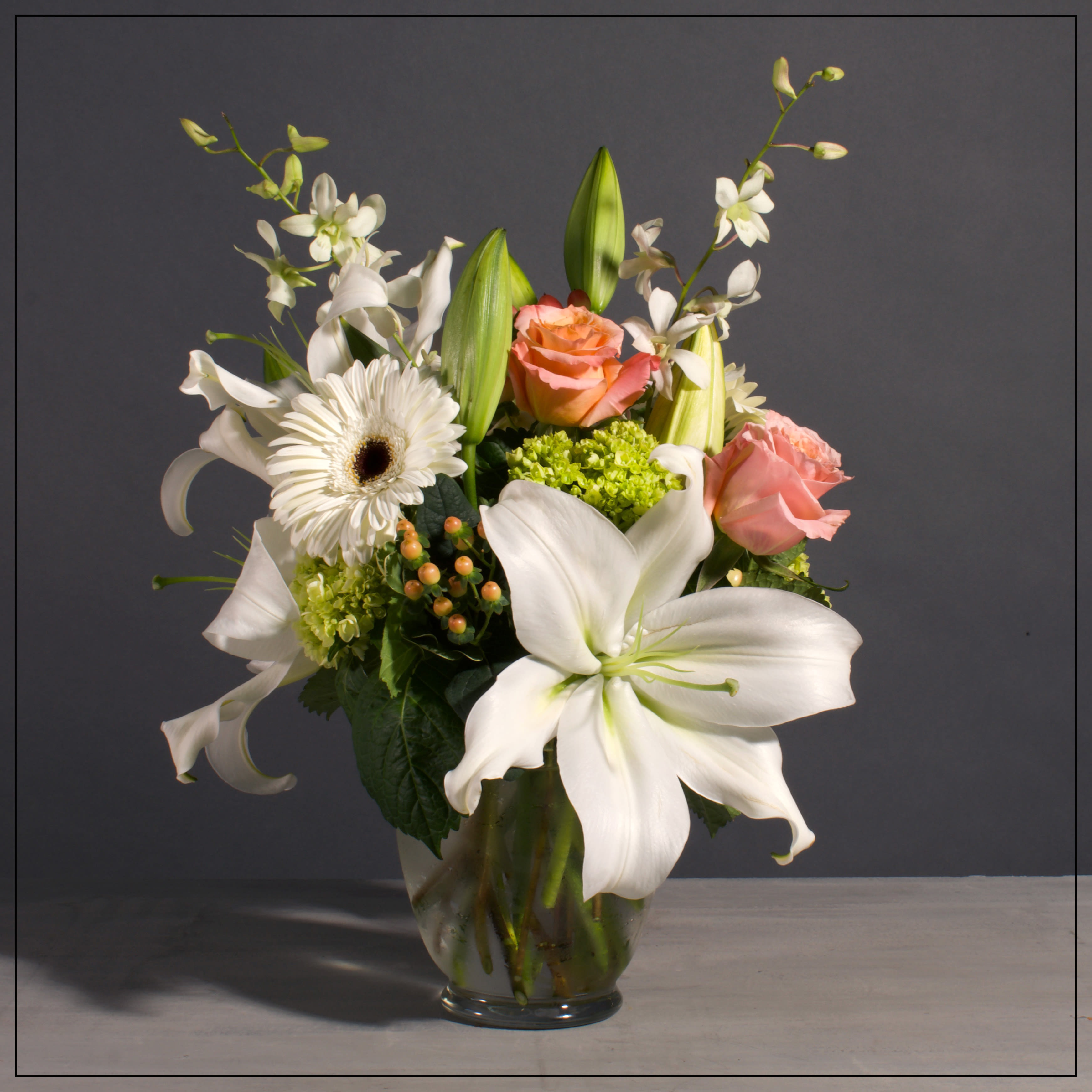 Coral and Cream - Seasonal mixed arrangement with white and coral tones. If this is out of the Kansas City metropolitan area, substitutions will be made.  Approximately 15 H x 13 W