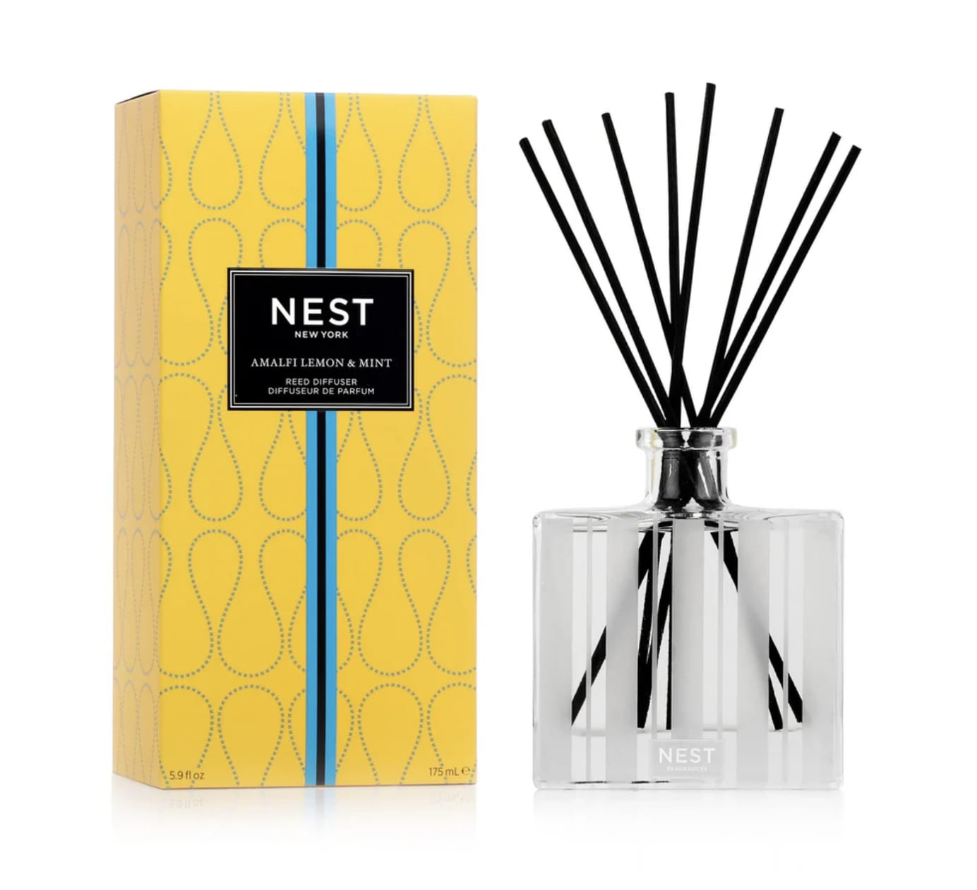 Yellow boxed NEST reed diffuser with clear glass bottle and black fragrance reeds.