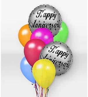 Cluster of colorful balloons with two silver anniversary balloons
