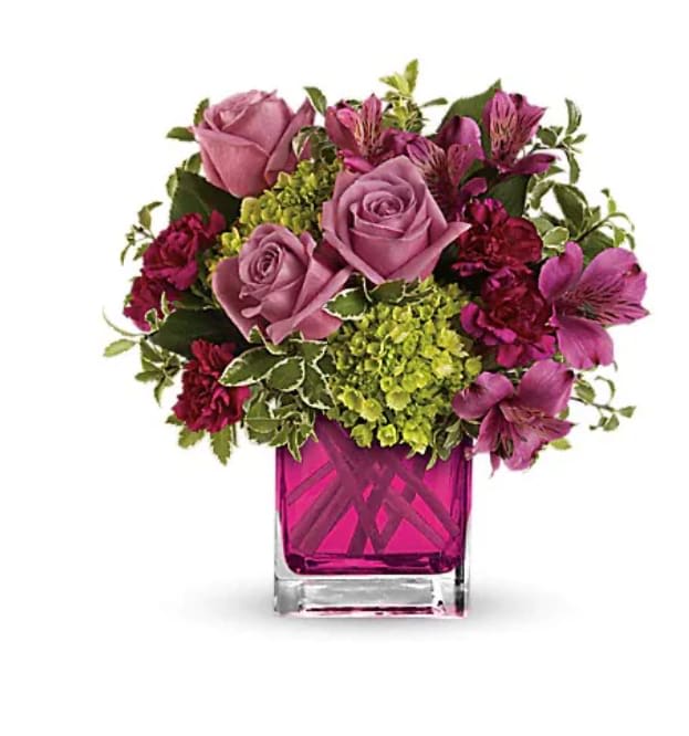 Splendid Surprise - Sweet as can be. This lovely arrangement includes green miniature hydrangea and lavender roses arranged in our adorable fuchsia cube. Green miniature hydrangea, lavender roses, purple alstroemeria and maroon miniature carnations accented with greens.  