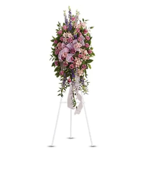 Tall pink and purple floral standing spray on an easel