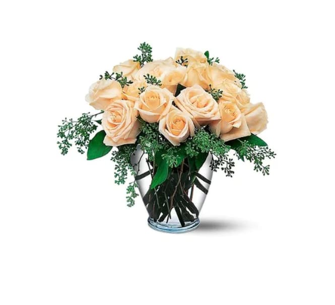 Peach roses arranged in a clear glass vase