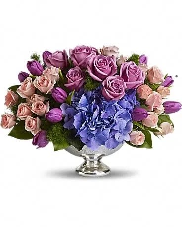 Purple Elegance Centerpiece - A masterpiece in purple. This lush, lavender array mixes beautiful blue hydrangea with happy purple tulips and luxurious lavender and pink roses. Presented in an elegant Mercury Glass Bowl, it's an exquisite choice for any important event, from weddings to showers. Purple tulips, blue hydrangea, lavender and pink roses are mixed with delicate ming fern and rich green salal in a magnificent Mercury Glass Bowl. 