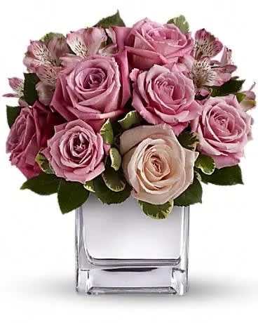 Rose Rendezvous Bouquet - Obviously designed with love, this exquisite array of pink and lavender roses in a contemporary silver cube vase is a real stunner. Softly spectacular, it is a gift that will touch her heart and excite her senses at the same time. It's that gorgeous! The exquisite bouquet includes light pink roses, medium pink roses, lavender roses and pink alstroemeria accented with fresh greenery. Delivered in contemporary glass cube. 