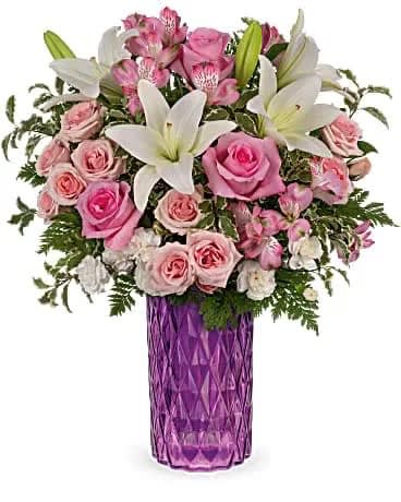 Rose Glam Bouquet - Gorgeous pink roses in a glamorous cut-glass vase make for a stunning Mother's Day surprise! The amethyst-hued keepsake is sure to be a dÃ©cor favorite for years to come. This bouquet features pink roses, pink spray roses, white asiatic lilies, miniature white carnations, pink alstroemeria, pitta negra and leatherleaf fern. Delivered in an Amazing Amethyst vase. 