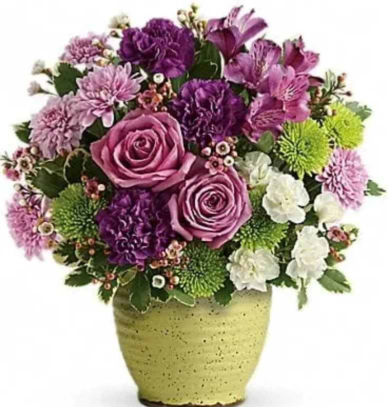 Spring Speckle Bouquet - Inspired by Japanese pottery, this hand-speckled, hand-glazed stoneware pot is a splendid spring gift--especially when filled with a lush lavender bouquet! Lavender roses, purple alstroemeria, purple carnations, white miniature carnations, green cushion spray chrysanthemums, and lavender cushion spray chrysanthemums are accented with pink waxflower and variegated pittosporum. Delivered in a Spring Speckle Pot. 