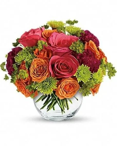 Smile for Me - Rekindle warm feelings with this sweet but sizzling array of hot pink roses, orange spray roses, purple carnations and more in a sparkling glass bubble bowl. A gorgeous gift of love for an anniversary or any romantic occasion. Expect kisses. This exciting bouquet includes hot pink roses, orange spray roses, green button spray chrysanthemums, purple carnations and bupleurum. Delivered in a glass bubble bowl. 