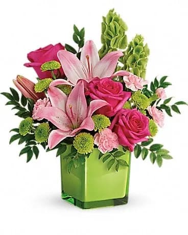 In Love With Lime Bouquet - Lime-a-licious! Fresh shades of green are a great way to contrast pink roses and lilies. Hand-delivered in a lovely leaf green cube, it's a loving gift any day of the week! This refreshing arrangement features dark pink roses, pink asiatic lilies, pink miniature carnations, bells of ireland, green button spray chrysanthemums, and huckleberry. Delivered in a glass cube.Approximately 14" W x 15" H 