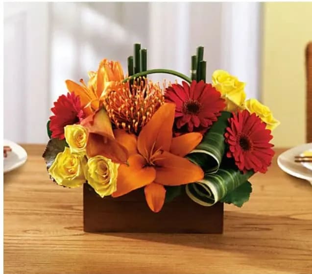 Colorful floral arrangement in a rectangular wooden container