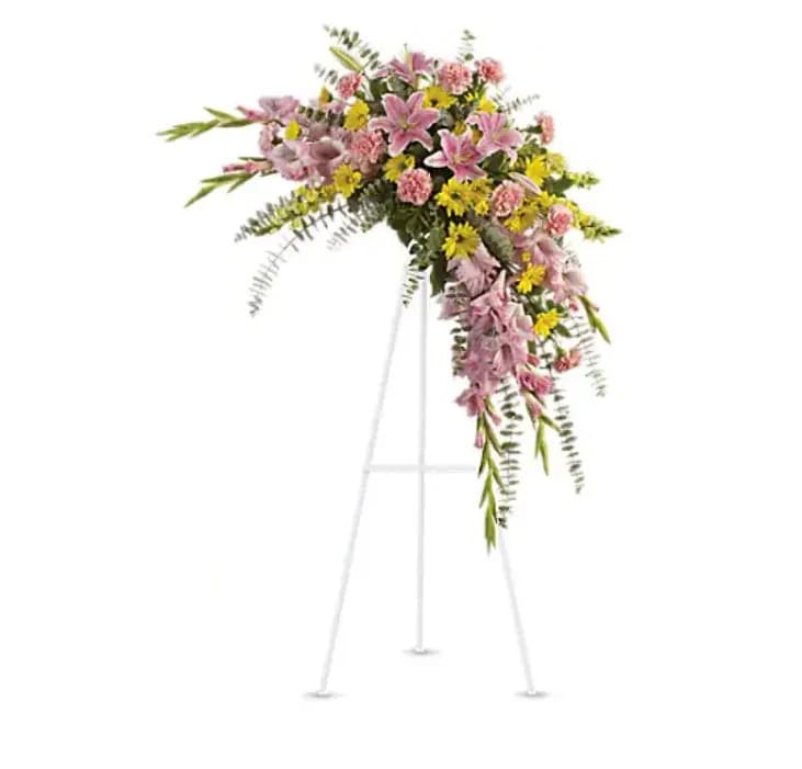 Sweet Solace Spray - Rejoice with this softly dramatic cascade of pink and yellow blooms - lilies, gladioli and chrysanthemums - that has hints of eucalyptus and variegated greens. Stems of flowers such as pink lilies, gladioli and carnations with yellow snapdragons, and daisy spray mums, accented by variegated greens and eucalyptus. 