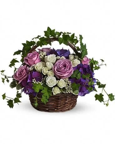 A Full Life - Even in mourning it is important to remember and honor a life well lived. This beautiful basket of purple and white flowers blended with vibrant greenery is a wonderful way to pay tribute to one who has indeed lived a full life. Brilliant flowers such as purple hydrangea, lavender roses, white spray roses and waxflower are arranged with beautiful ivy and more in a lovely round basket. 