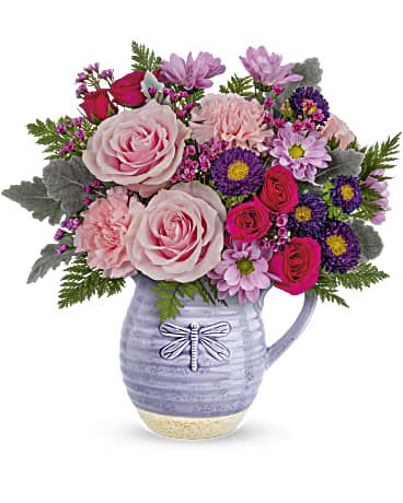 Playful Pitcher Bouquet  - Gorgeous roses and a keepsake pitcher--it's the perfect 2-in-1 gift! Take their special day to new heights with this pink-tastic bouquet and glazed, food-safe ceramic pitcher with charming dragonfly motif. Pink roses, hot pink spray roses, purple matsumoto asters, pink carnations and lavender daisy spray chrysanthemums are arranged with lavender waxflower, dusty miller and leatherleaf fern. Delivered in a Whimsical Dragonfly pitcher.   Approximately 14 1/2" W x 14 1/2" H