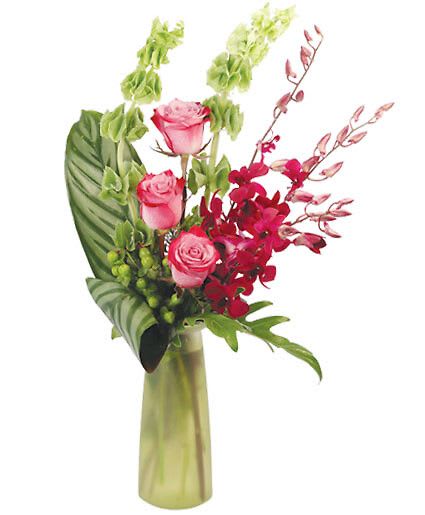 Plum Wonderful - Frosted Green Milk Bottle Vase, Greens: Calathea, Fatsia, Flowers: Bells Of Ireland, Green Hypericum, Purple Waxflower, Deep Purple Roses, Purple Dendrobium Orchids.