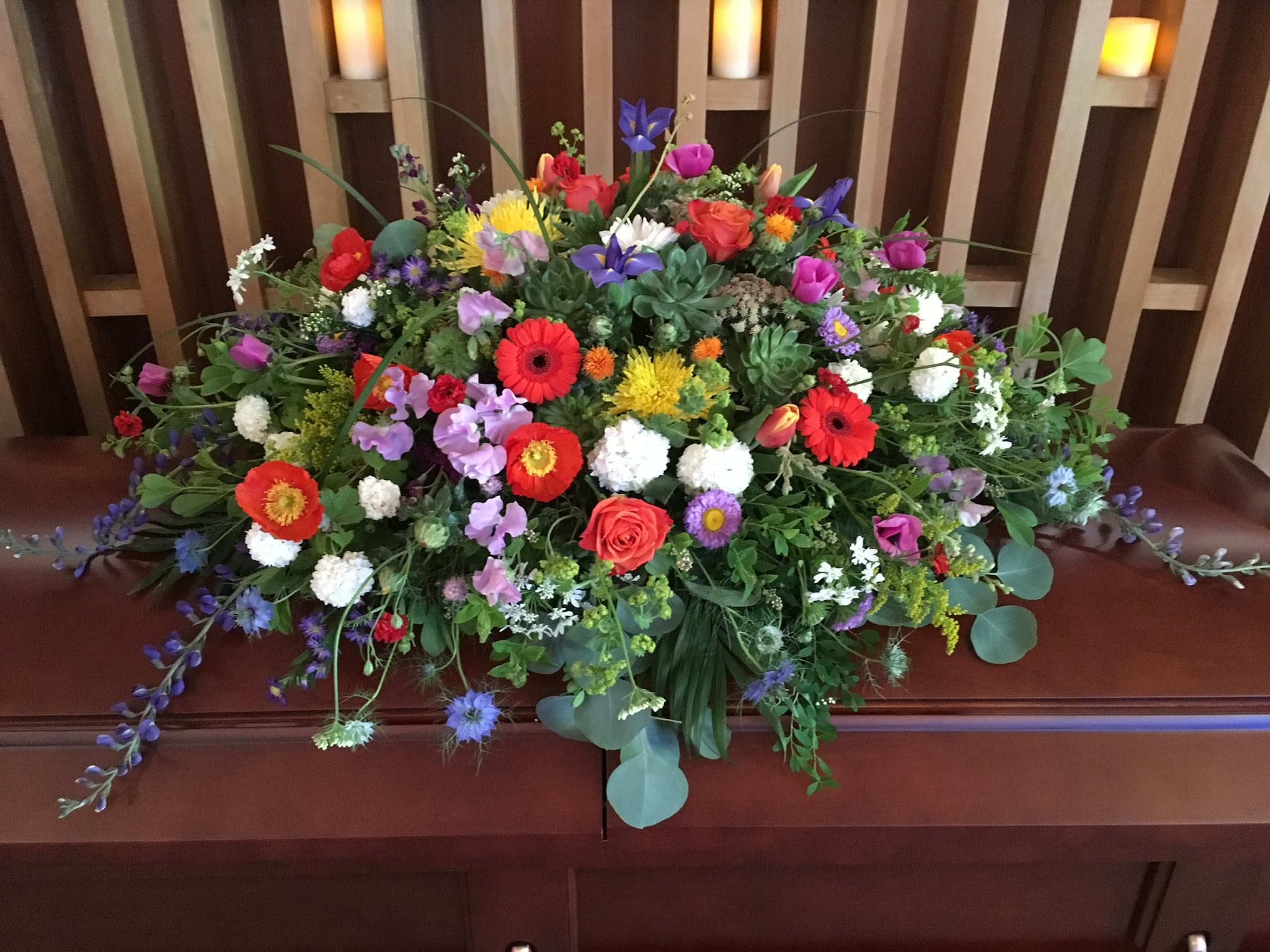 Large colorful floral casket spray with mixed blooms
