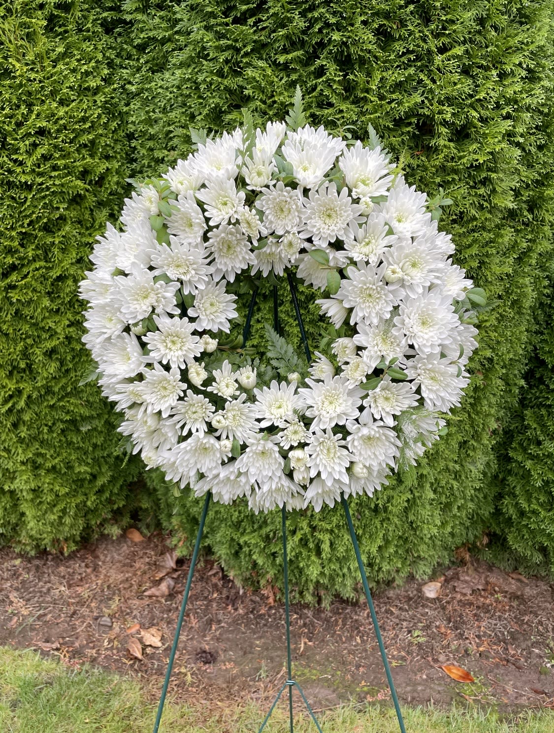 White chrysanthemum wreath on a standing easel