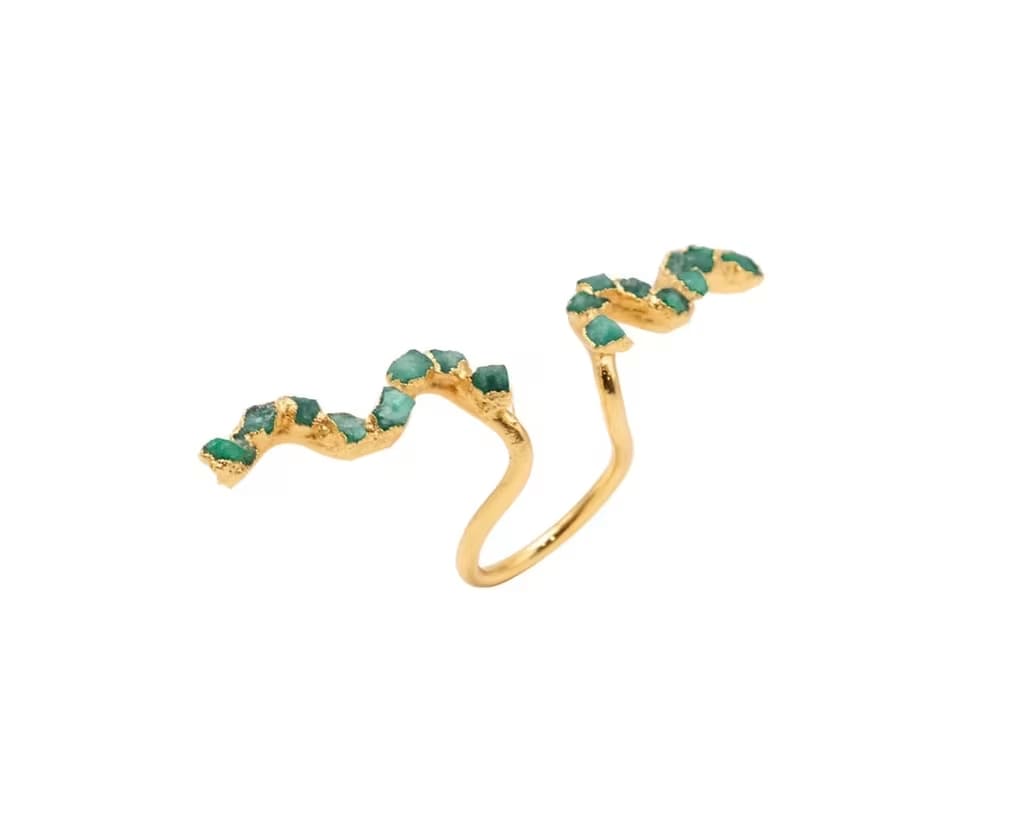 Gold ring with two green stone accents