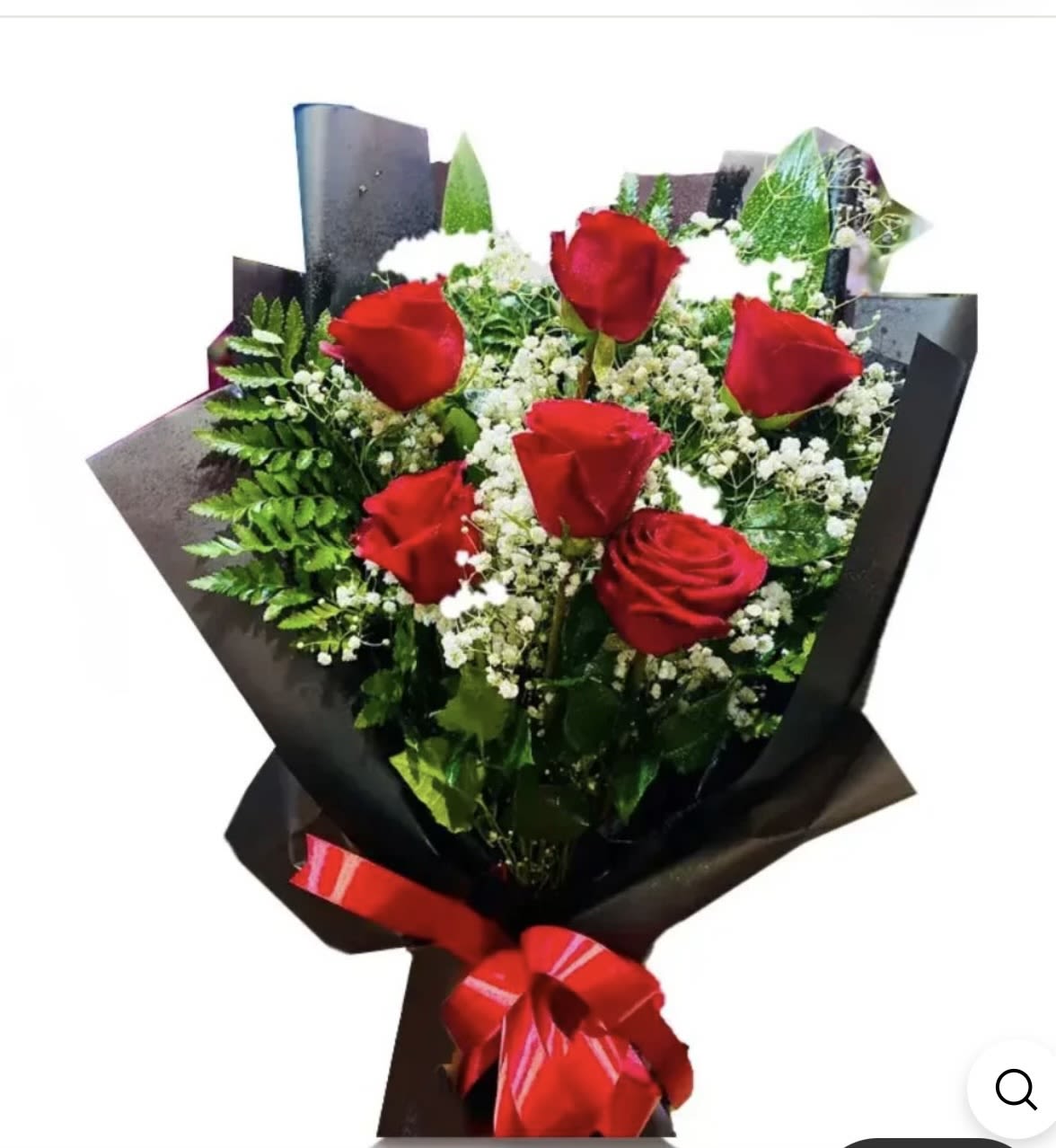 Bouquet of red roses with white filler flowers wrapped in black paper