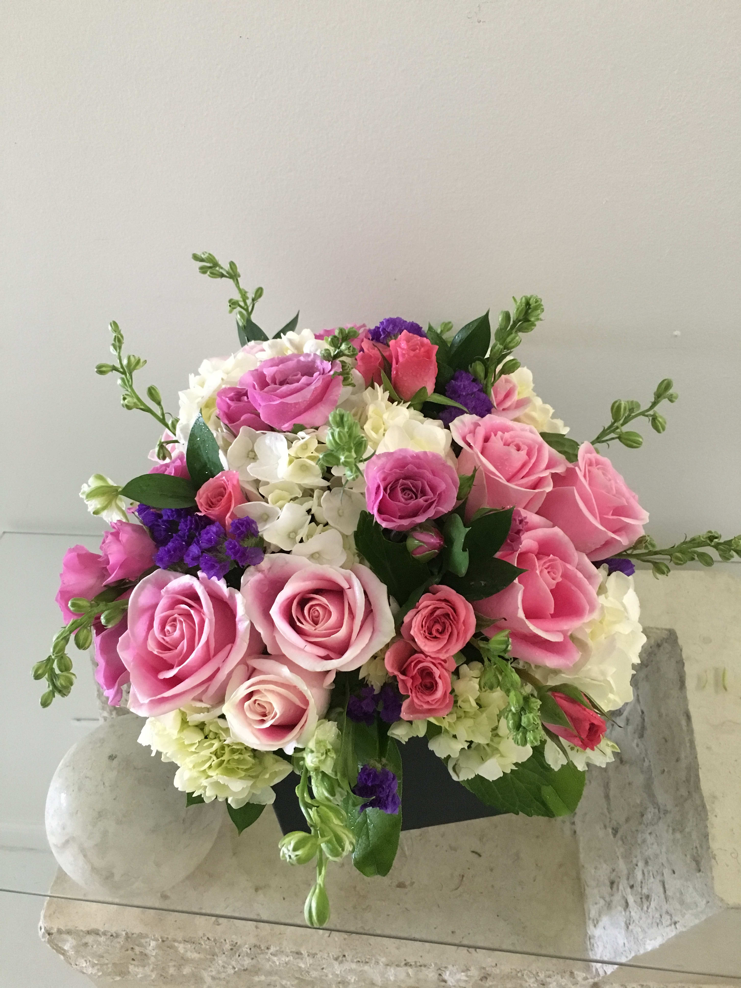 Bouquet of pink and white roses with purple accents