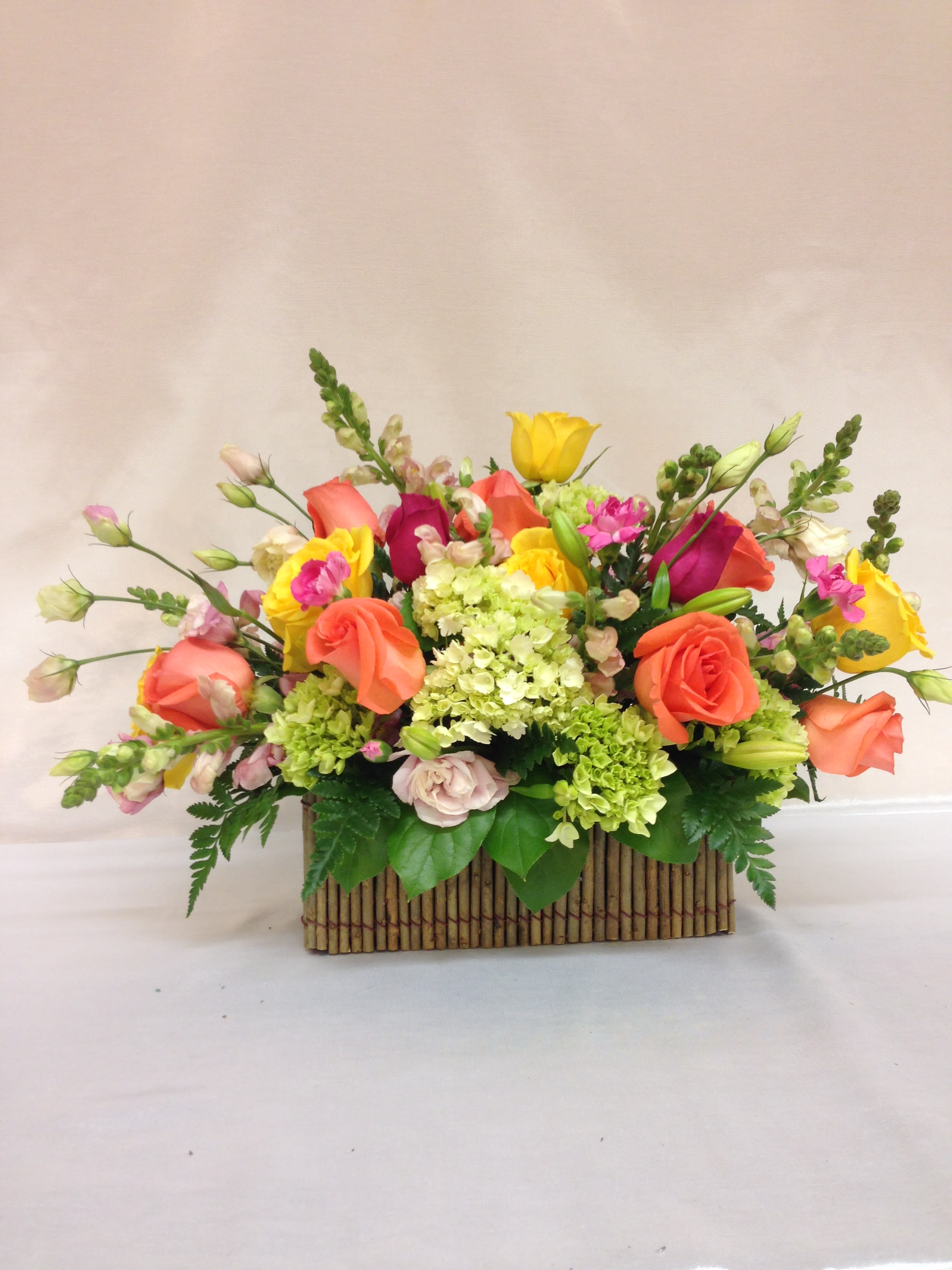 Colorful mixed flower arrangement in a rectangular basket
