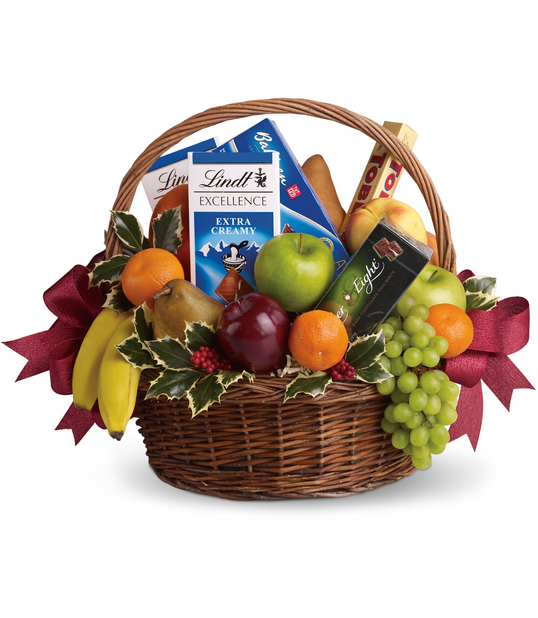 Fruits and Sweets Christmas Basket  - Even if your gift list seems like it's endless this year, sending anyone a sweet holiday gift is beautifully easy. This basket is fresh, festive and fabulous. Oh, and did we mention delicious?    Fresh green, red and yellow apples, bananas, grapes, pears and tangerines are arranged with an assortment of gourmet chocolate bars and cookies. Add Christmas holly and red ribbons and you've got one heck of a healthy Christmas gift.    Approximately 19" W x 16" H      Please note: All of our bouquets and gift baskets are hand-arranged and delivered locally by professional florists. This item may require additional lead time so same-day delivery is not available.    Orientation: N/A        As Shown : T135-2A      Deluxe : T135-2B      Premium : T135-2C    